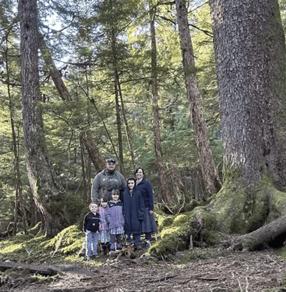 Family photo in the deep woods with Dad, Mom and 4 kids